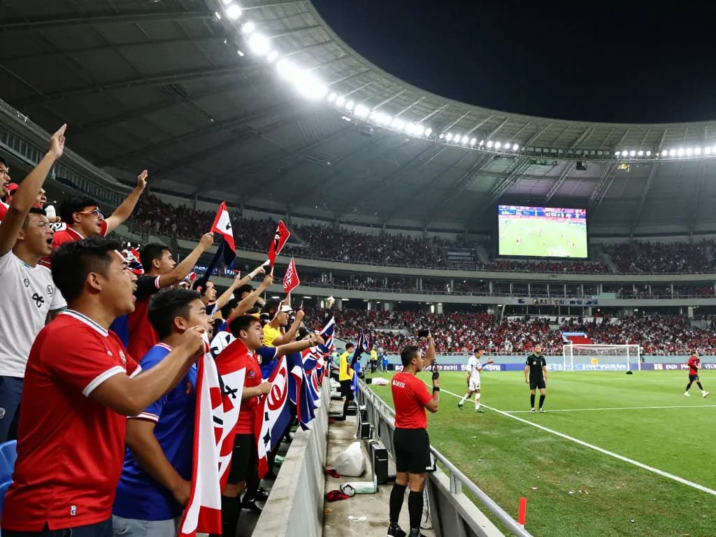 Exciting bóng đá 1gom match scene with fans cheering and players in action at a packed stadium.