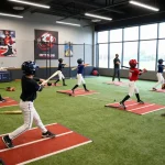Players training at Hit Club baseball facility, showcasing action and dedication.